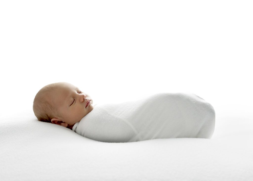 Newborn boy sleeping and wrapped in white cloth by Fort Worth Newborn Photographer