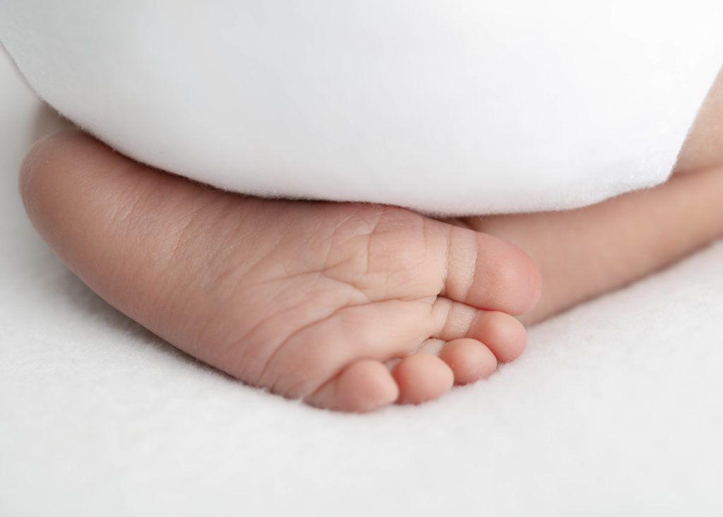 Newborn baby close up on baby's feet and bottom by Grapevine Newborn Photographer