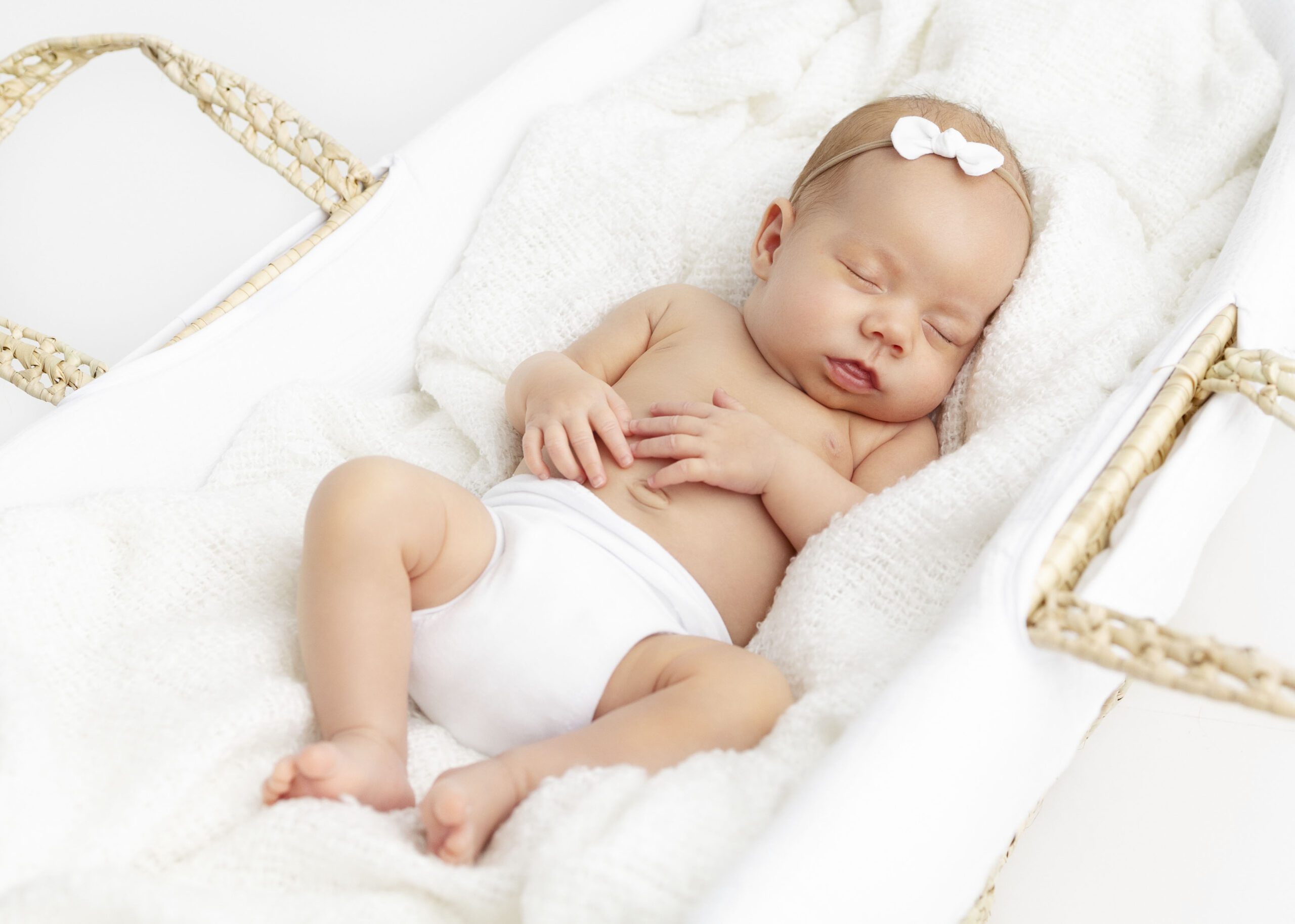 Dallas newborn baby girl sleeping in a moses basket