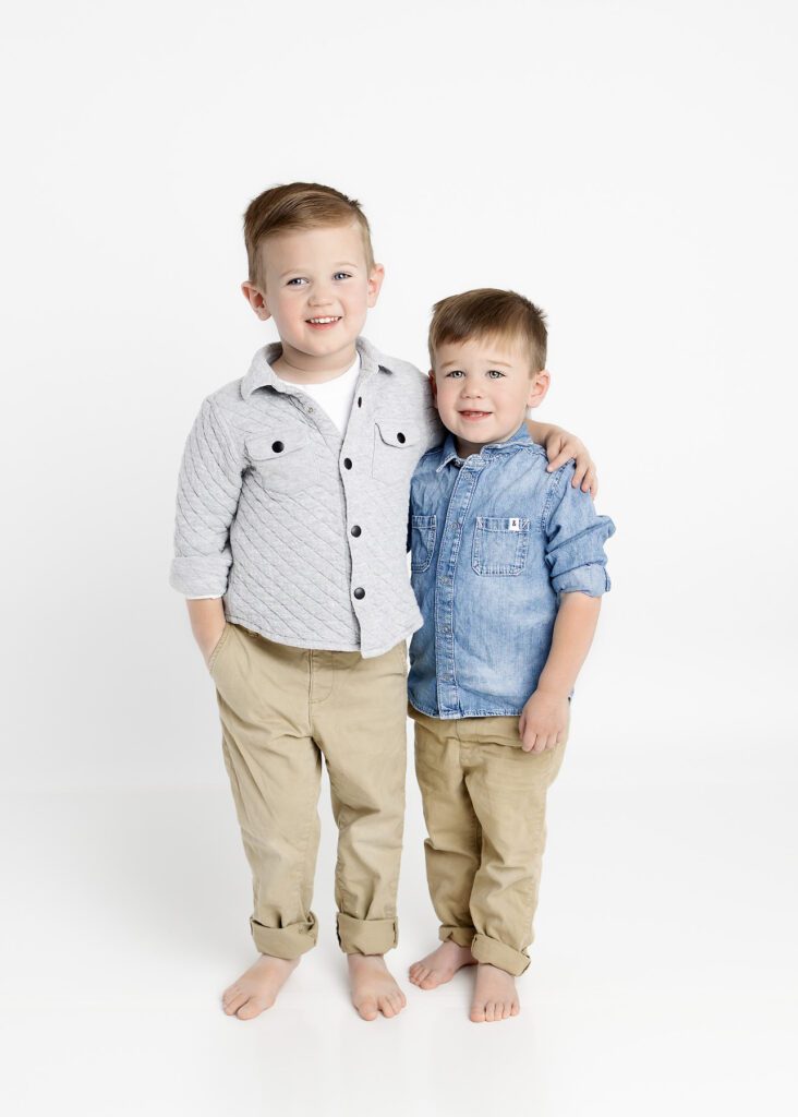 Toddler brothers with arms around each other by Dallas Portrait photography