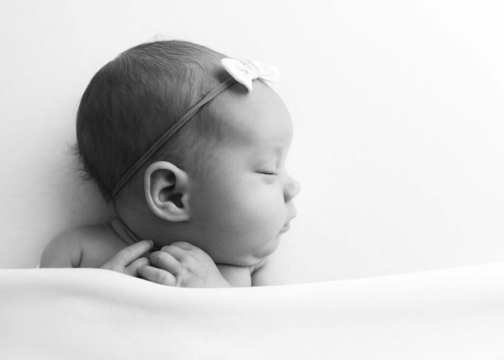 Newborn baby girl sleeping by newborn photography Dallas TX