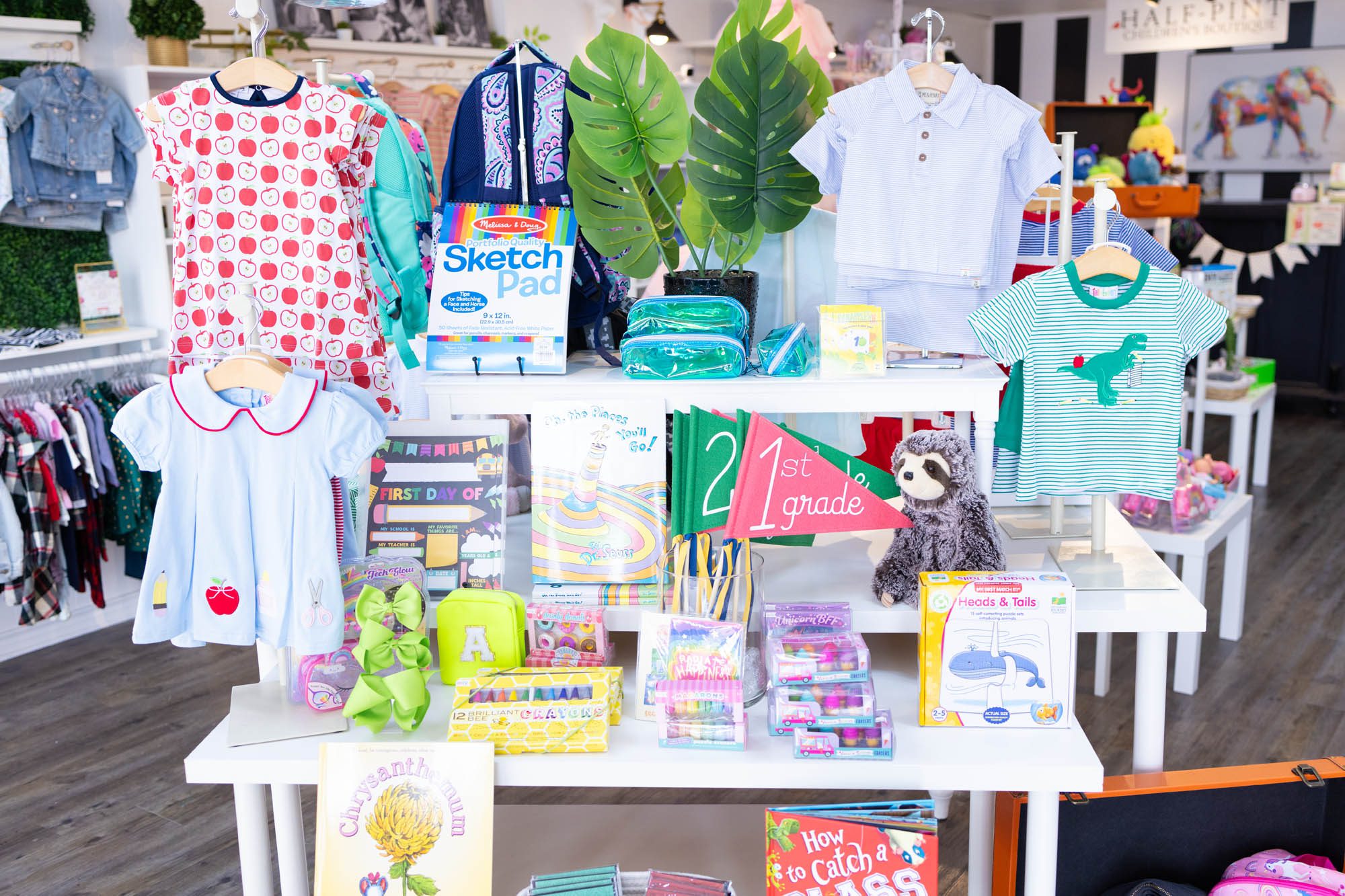 Display of kids clothes and fun books by favorite Dallas Baby Boutique