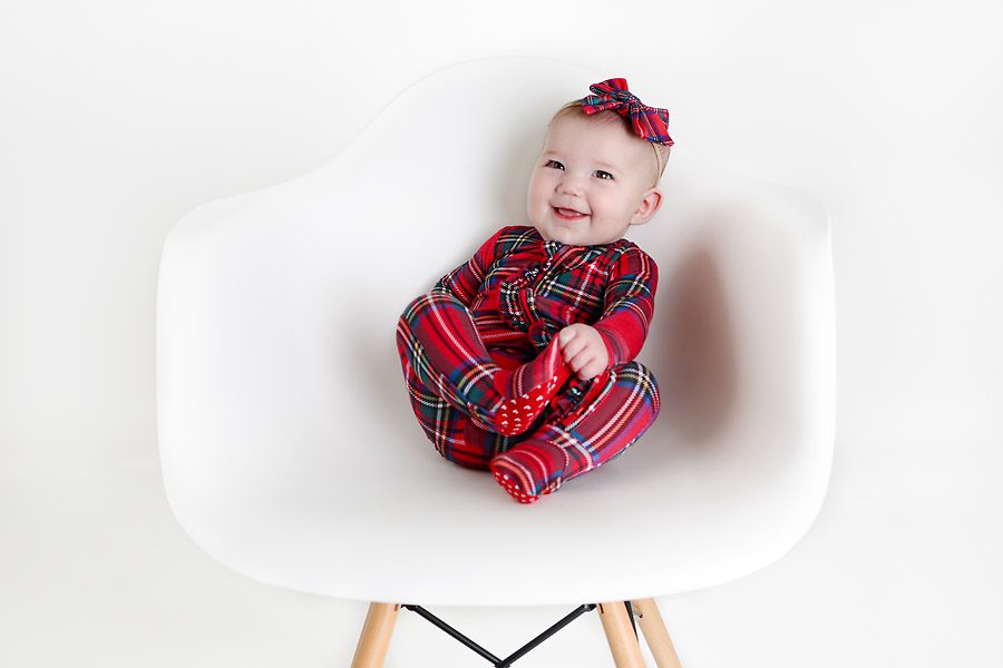 Baby girl in Christmas pajamas for pictures with Santa Dallas TX